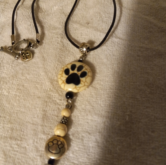 Handmade black leather cording necklace with cream bead with 🐾 print design. - Picture 4 of 4